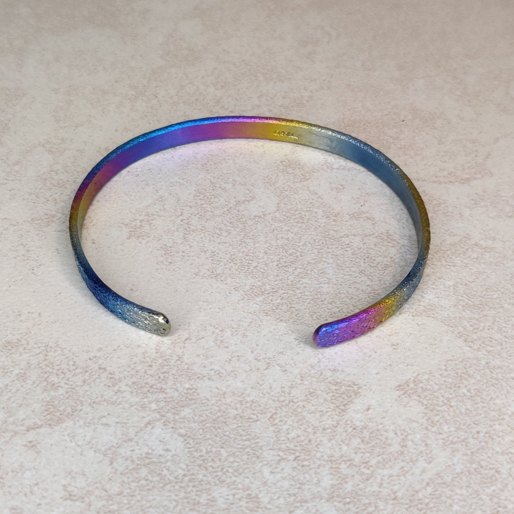 Niobium Bracelet With Rainbow Finish and a Light Mock Pavé ™ © Texture